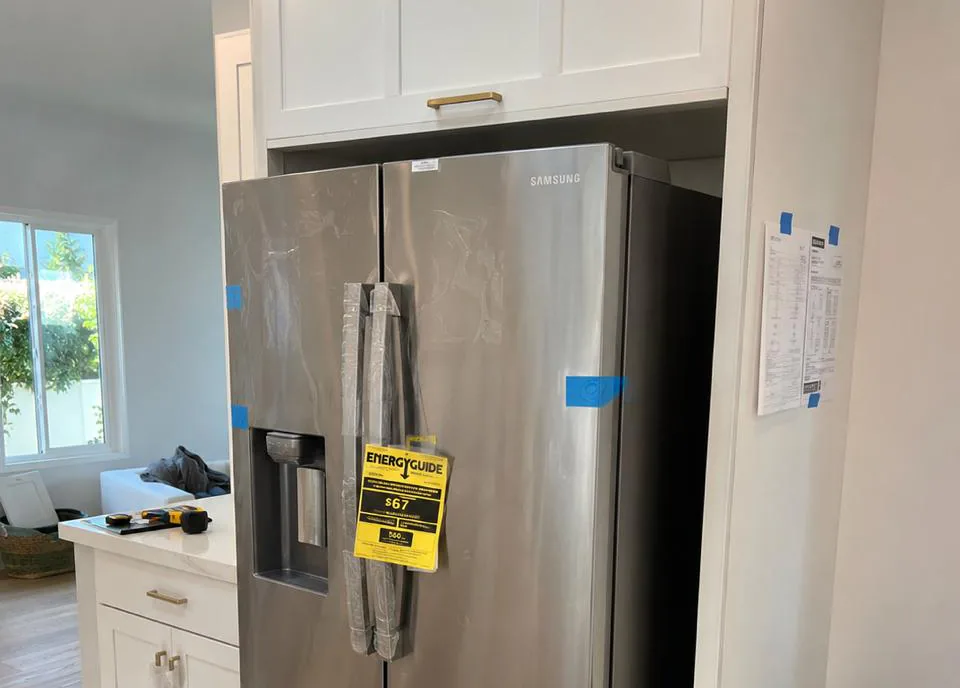 Owner-operated appliance repair technician servicing a refrigerator in an Orange, California kitchen near Old Towne and the historic Plaza